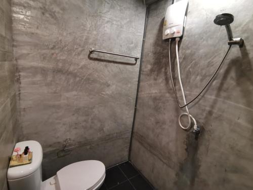a bathroom with a toilet and a shower at 8 SLEEPER STREET Guesthouse in Krabi town