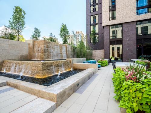a fountain in a courtyard in front of a building at Global Luxury Suites at Reston Town Center in Reston