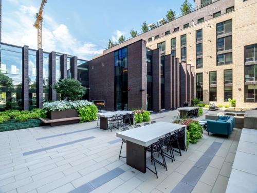 a patio with tables and chairs in front of a building at Global Luxury Suites at Reston Town Center in Reston