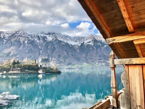 a view of a house on an island in the water at Hotel Châlet Du Lac in Iseltwald
