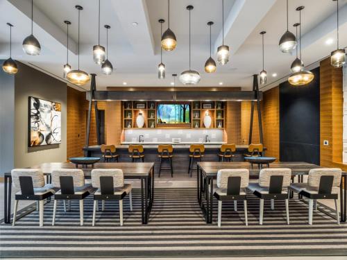 a rendering of a dining room with tables and chairs at Global Luxury Suites at Reston Town Center in Reston