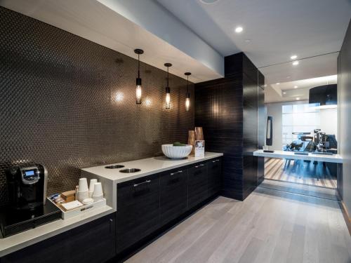 a kitchen with black cabinets and a white counter top at Global Luxury Suites at Reston Town Center in Reston