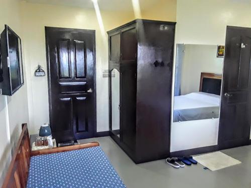 a room with a bathroom with a shower and a bed at Adayo Cove Resort in Siquijor