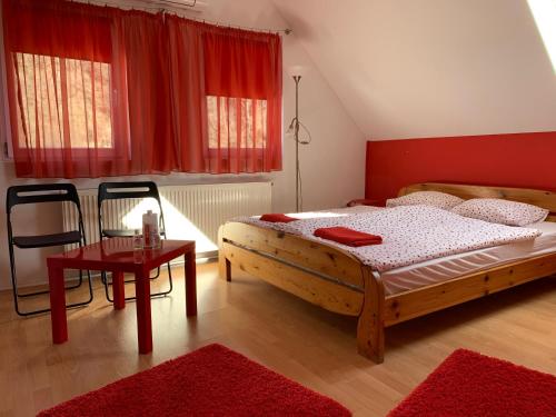 a bedroom with a large wooden bed and a table at Panni Vendégház in Egerszalók