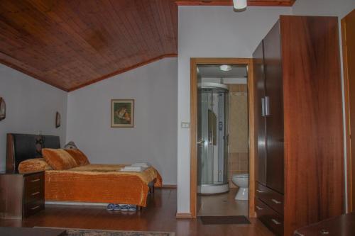 1 Schlafzimmer mit einem Bett und einem Bad in der Unterkunft Hotel Bleta in Gjirokastër