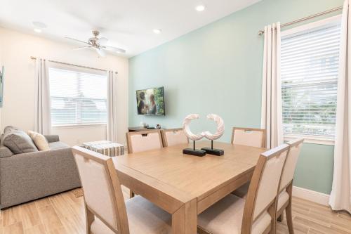 a dining room with a wooden table and chairs at Margaritaville Cottages Orlando with H2O Waterpark by Rentyl in Kissimmee