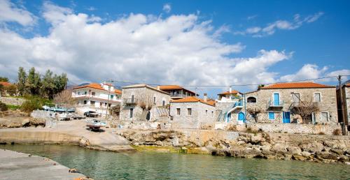 a group of buildings next to a river at Mani Stone Towers in Kotrónion