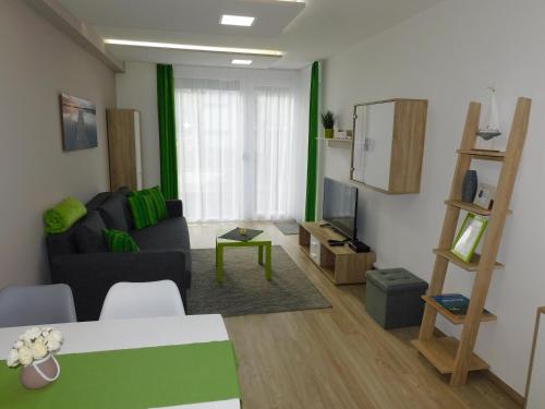 a living room with a couch and a television at Katamaran in Siófok