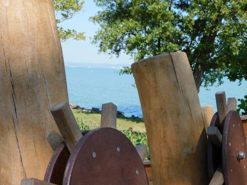 a wooden fence with a view of the ocean at Katamaran in Siófok