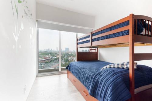 a bedroom with a bunk bed and a large window at San Ángel - UNAM apartment 2parking 3BR 2BA in Mexico City