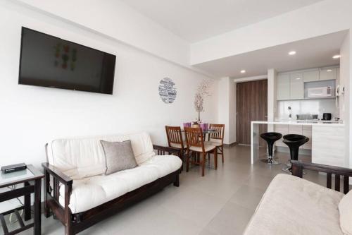 a living room with a couch and a kitchen at San Ángel - UNAM apartment 2parking 3BR 2BA in Mexico City