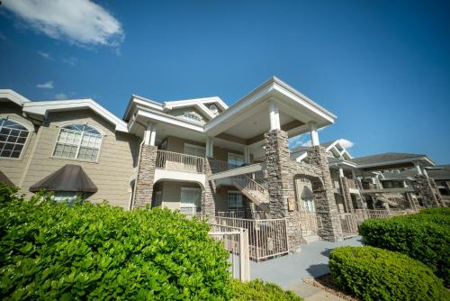 a large house with bushes in front of it at Legacy at Thousand Hills in Branson
