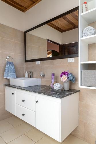 a bathroom with a sink and a mirror at Casa Sofia, every stay comes with a free professional massage in Orosí