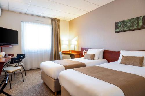 Un ou plusieurs lits dans un hébergement de l'établissement Quality Hotel Pau Centre Bosquet
