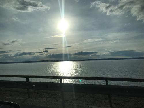 a sun setting over a body of water at Peeneurlaub in Lassan