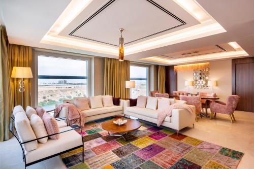 a living room with a couch and a table at Crowne Plaza Muscat OCEC by IHG in Muscat