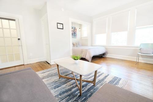 a living room with a table and a bed at The 1920s Mainstay Studio Flat on Lower Greenville in Dallas