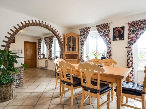 a kitchen and dining room with a wooden table and chairs at Charming gite in Waimes near Spa Francorchamps in Waimes