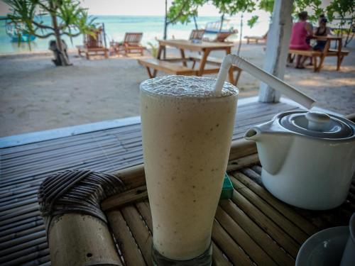a drink sitting on a table on the beach at Salili Bungalow in Gili Air