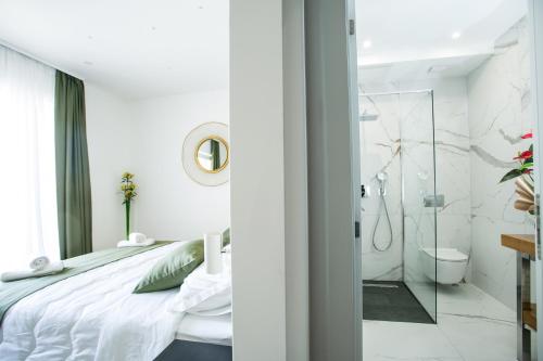 a bedroom with a large bed and a bathroom at Kaša Rooms 2 in Split