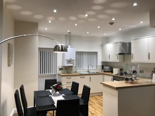 a kitchen with a table and a dining room at Parliament in Gloucester