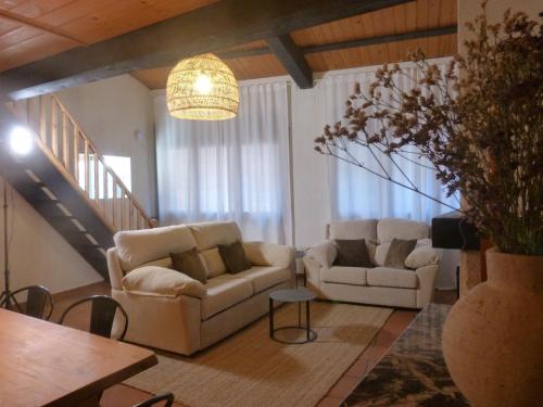 a living room with two couches and a table at El Paller de Can Puig a la Pera 4/6 pax in La Pera