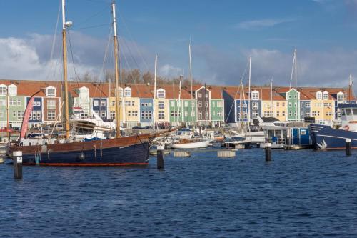 a group of boats docked in a harbor with buildings at CasaLuca in Hellevoetsluis