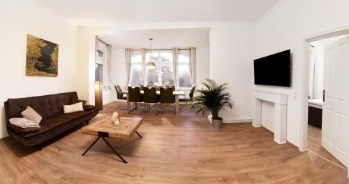 a living room with a couch and a table at Villa am Park in Meiningen