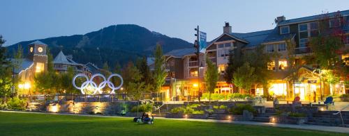 a group of buildings in a park at night at Tyndall Stone Lodge by Whiski Jack in Whistler