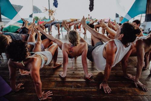 a group of people doing yoga on the beach at Selina Playa Venao in Playa Venao