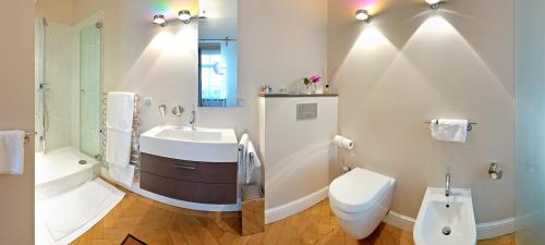 a white bathroom with a sink and a toilet at Hotel Liebig in Frankfurt