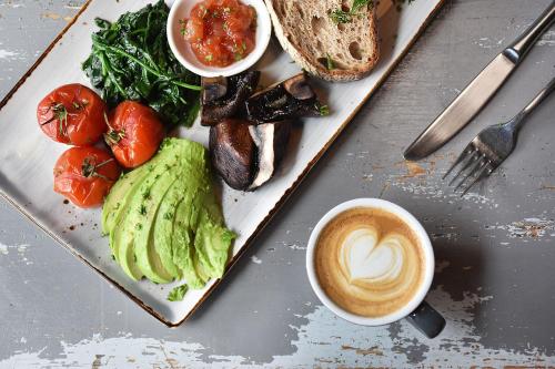 a plate of food with a sandwich and a cup of coffee at The Hotel Britomart in Auckland