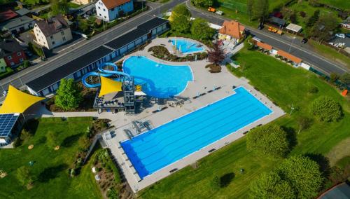 an overhead view of a large swimming pool in a park at Caffe Boulevard Penzion in Waldsassen