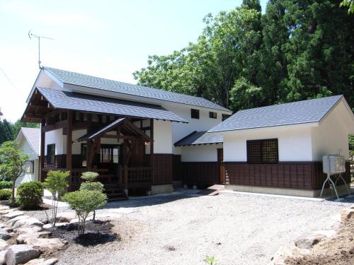 a white house with a black roof at Cottage All Resort Service / Vacation STAY 8448 in Inawashiro