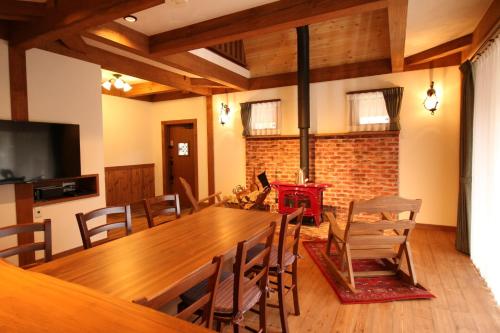 a dining room with a large wooden table and chairs at Cottage All Resort Service / Vacation STAY 8450 in Inawashiro