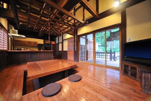 Habitación grande con mesa de madera y TV. en Cottage All Resort Service / Vacation STAY 8448, en Inawashiro