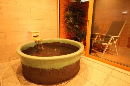 a bucket of water in a room with a chair at Cottage All Resort Service / Vacation STAY 8450 in Inawashiro