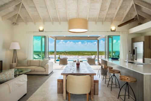 an open kitchen and living room with a view of the ocean at Sailrock South Caicos - Island Hop Flight Included in South Caicos