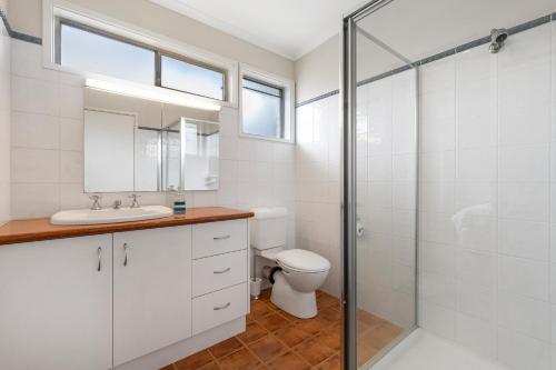 a bathroom with a toilet and a sink and a shower at Blairgowrie Beach Baby in Blairgowrie
