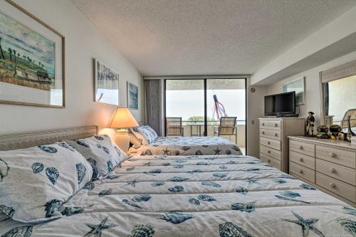 a bedroom with two beds and a television and a window at Gulf Coast Escape with Balcony and Resort Amenities! in Hudson