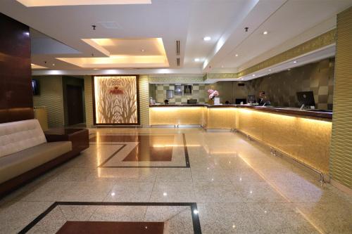 a lobby of a hotel with a bar at Hotel Grand Continental Kuala Lumpur in Kuala Lumpur
