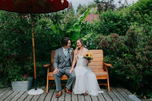 a bride and groom sitting on a bench at Wisteria Guest House in Ganges