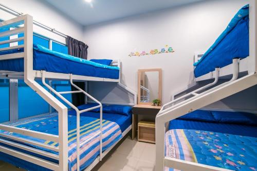 a bedroom with two bunk beds and a mirror at 4U Pool Villa in Cha Am