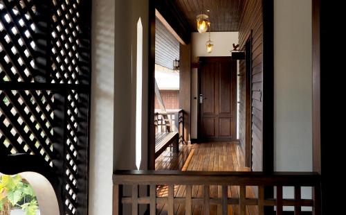 a hallway of a house with a wooden door at คุ้มสะเมิง-Samoeng Center in Samoeng