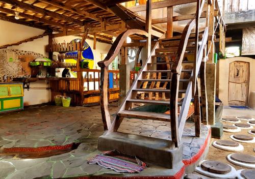 a staircase in the middle of a room at The Rabbit Tree Hostel in Gili Meno