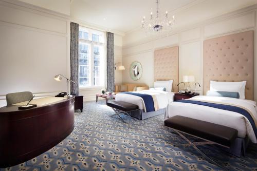 a hotel room with two beds and a chandelier at The Tokyo Station Hotel in Tokyo