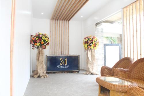 a living room with a tv and two trees at Monallan Boracay Hotel in Boracay