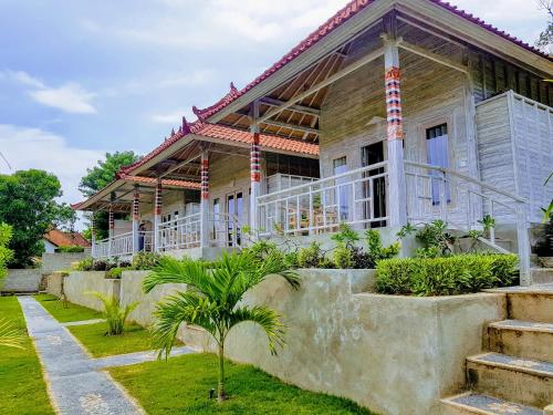 a house with a staircase in front of it at Mesari Hut Lembongan in Nusa Lembongan