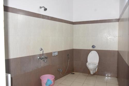 a bathroom with a toilet and a shower at Natraj Hotel in Darbhanga