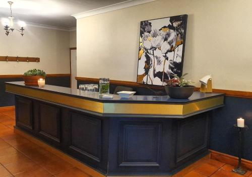 a bar in a waiting room with flowers on the wall at The Lancefield Lodge in Lancefield